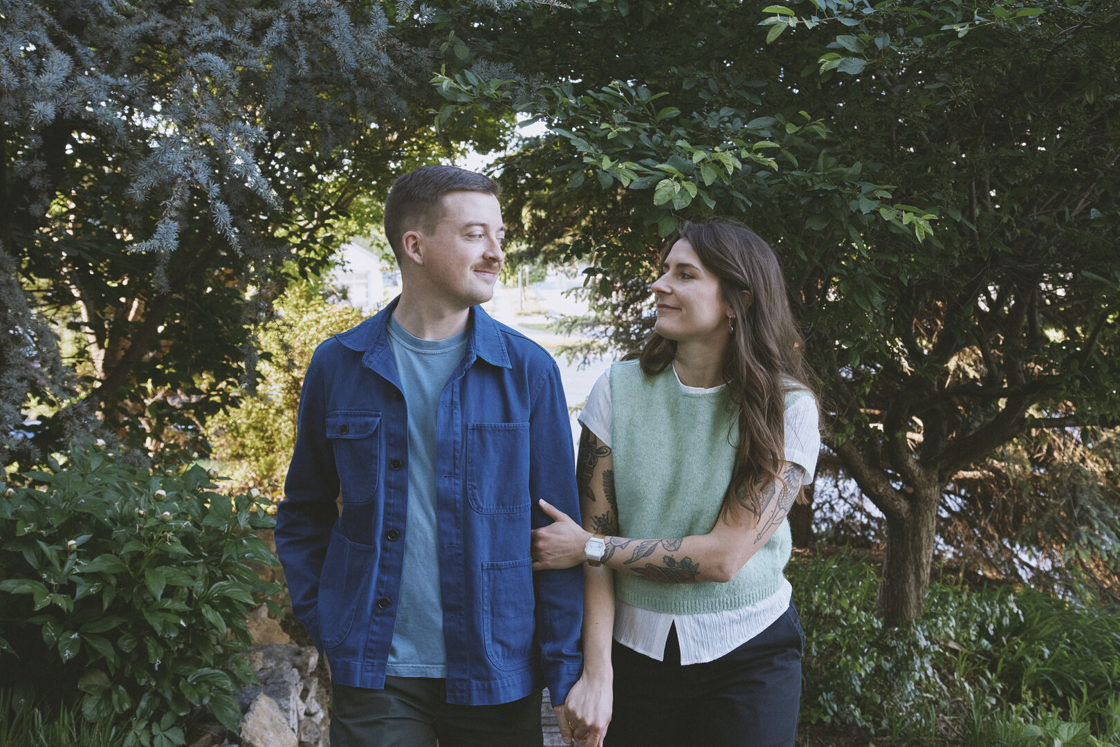 Andy and Brit embracing among trees in nature