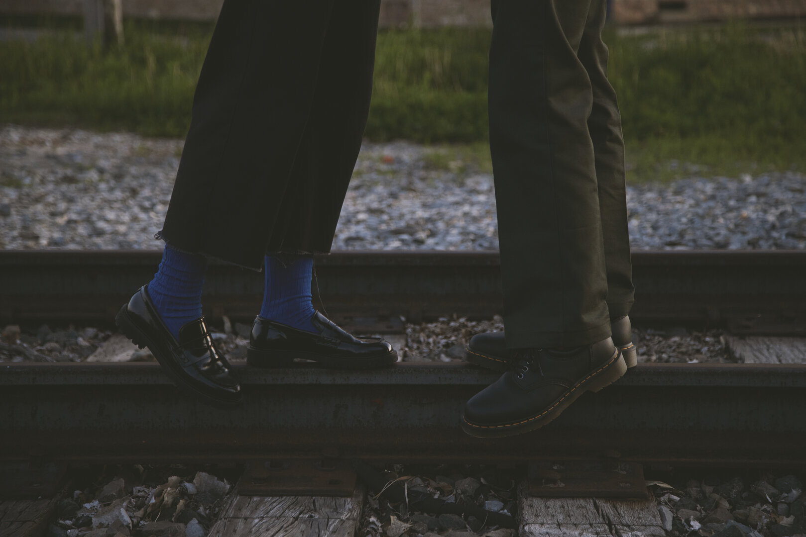 Andy and Brit's feet walking on railroad tracks