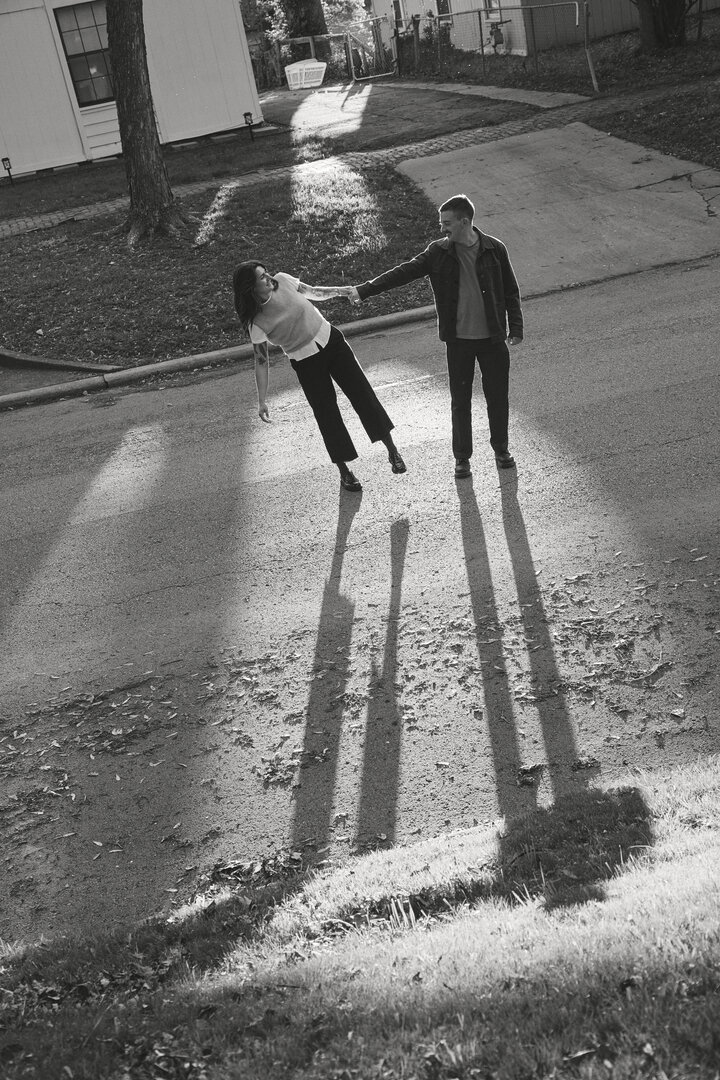 Black and white photo of Andy and Brit dancing in the street